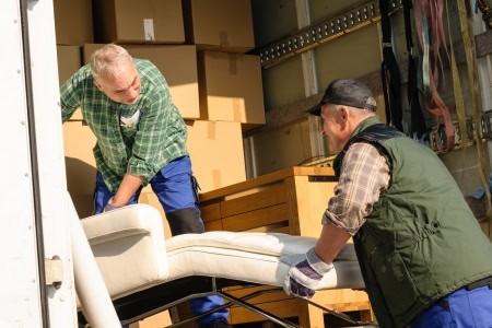 13321434 – two male movers putting furniture and boxes in moving truck 13321434 - two male movers putting furniture and boxes in moving truck